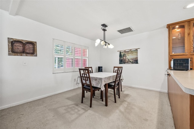 603 Royal Crest Dr, Brandon, FL 33511 - dining room with light colored carpet, baseboards, and a chandelier
