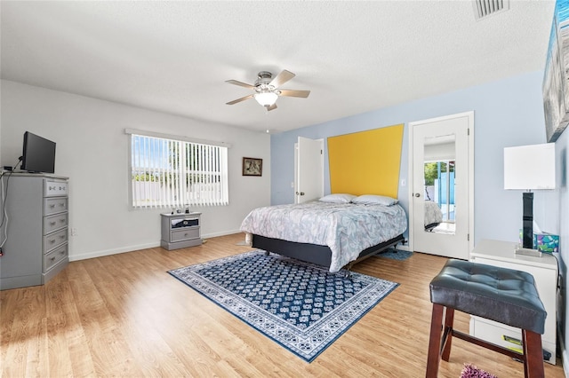 603 Royal Crest Dr, Brandon, FL 33511 - bedroom featuring light wood-style floors, a ceiling fan, a textured ceiling, baseboards, and access to exterior