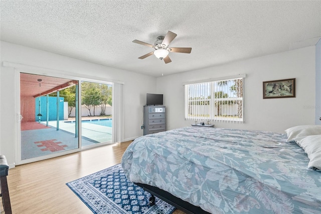 603 Royal Crest Dr, Brandon, FL 33511 - bedroom featuring wood finished floors, access to exterior, a textured ceiling, and a ceiling fan