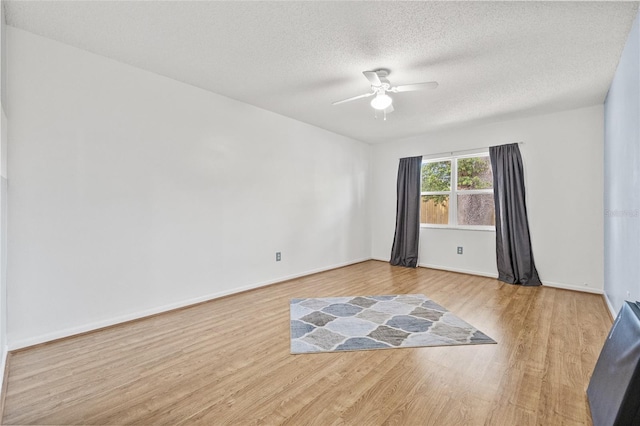 603 Royal Crest Dr, Brandon, FL 33511 - unfurnished room featuring ceiling fan, wood finished floors, a textured ceiling, and baseboards