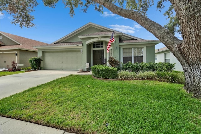 10449 Hunters Haven Blvd, Riverview, FL 33578 - single story home with stucco siding, a garage, a front lawn, driveway, and a shingled roof