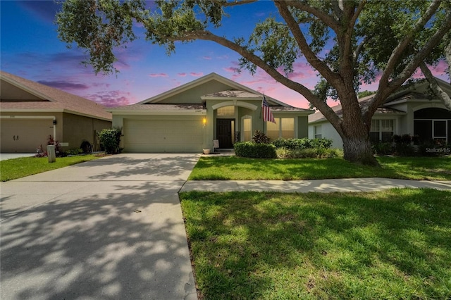 10449 Hunters Haven Blvd, Riverview, FL 33578 - ranch-style home featuring an attached garage, driveway, a yard, and stucco siding