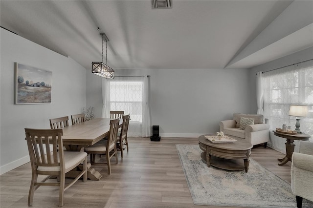 10449 Hunters Haven Blvd, Riverview, FL 33578 - dining area with vaulted ceiling, baseboards, and light wood-style flooring