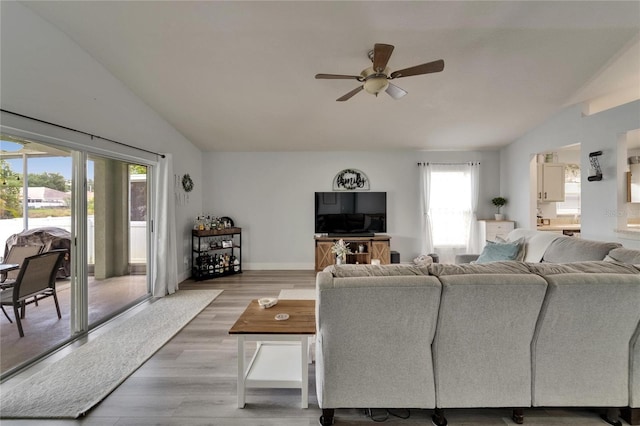 10449 Hunters Haven Blvd, Riverview, FL 33578 - living room with lofted ceiling, ceiling fan, light wood-type flooring, and baseboards
