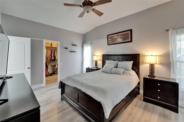 10449 Hunters Haven Blvd, Riverview, FL 33578 - bedroom with lofted ceiling, light wood-type flooring, a walk in closet, baseboards, and a closet