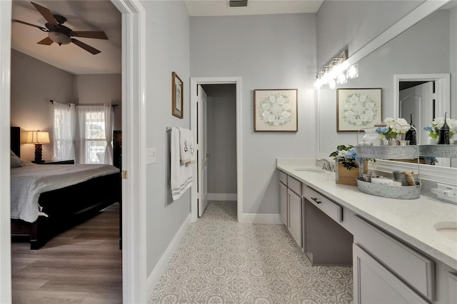 10449 Hunters Haven Blvd, Riverview, FL 33578 - bathroom featuring connected bathroom, double vanity, baseboards, and a ceiling fan