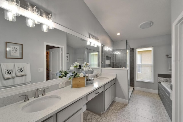 10449 Hunters Haven Blvd, Riverview, FL 33578 - bathroom featuring vaulted ceiling, double vanity, a garden tub, a shower stall, and tile patterned floors