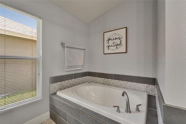 10449 Hunters Haven Blvd, Riverview, FL 33578 - full bathroom with a garden tub, healthy amount of natural light, and vaulted ceiling