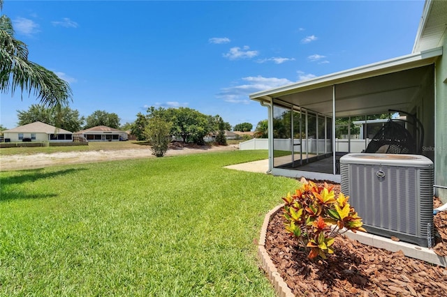 10449 Hunters Haven Blvd, Riverview, FL 33578 - view of green lawn with central AC unit, a sunroom, and a patio area
