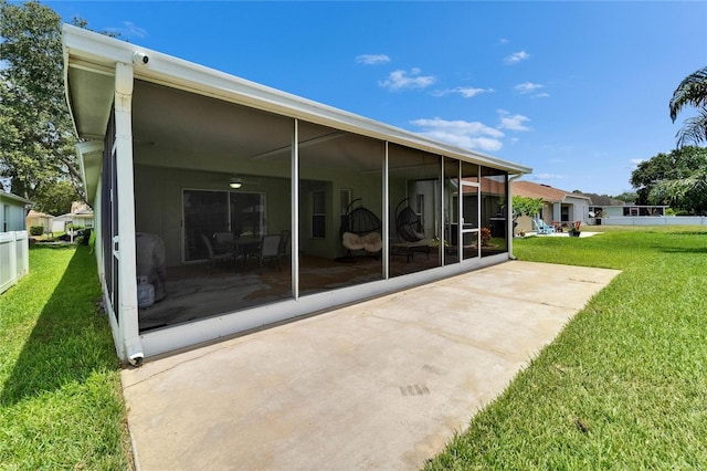 10449 Hunters Haven Blvd, Riverview, FL 33578 - rear view of house with a sunroom and a yard