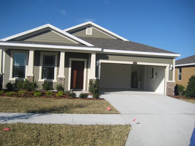 12202 Fairlawn Dr, Riverview, FL 33579 - craftsman inspired home featuring a garage, driveway, stone siding, a shingled roof, and a porch