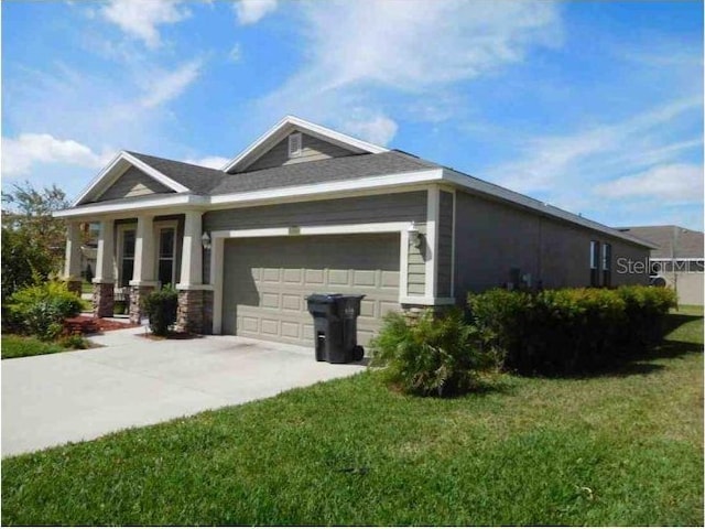 12202 Fairlawn Dr, Riverview, FL 33579 - view of side of home featuring a garage, a lawn, and concrete driveway