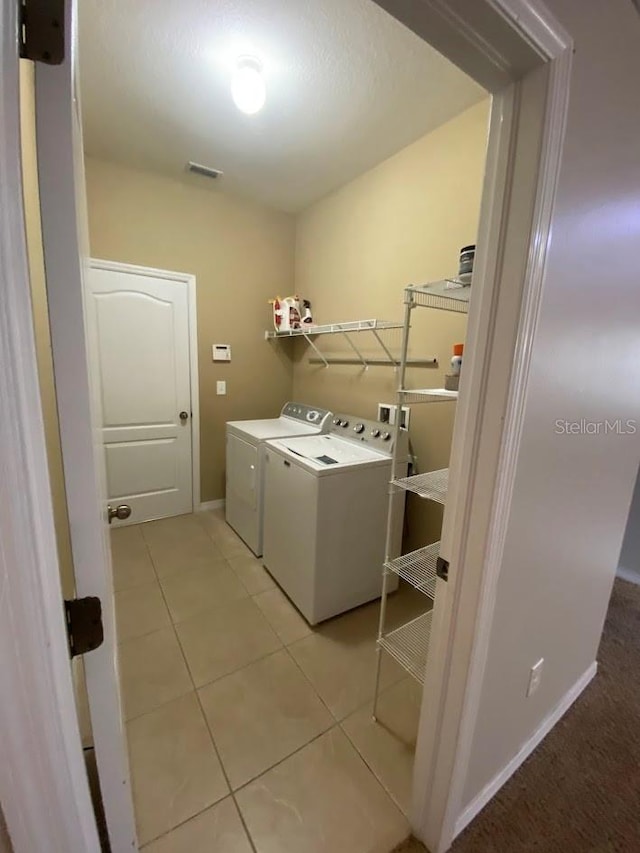 12202 Fairlawn Dr, Riverview, FL 33579 - laundry room with independent washer and dryer, light tile patterned flooring, and baseboards