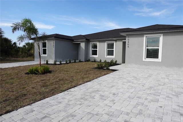 17099 Carleen Ave, Port Charlotte, FL 33948 - view of front of house with stucco siding and a front yard