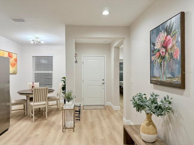 17099 Carleen Ave, Port Charlotte, FL 33948 - foyer entrance featuring light wood finished floors, baseboards, and recessed lighting