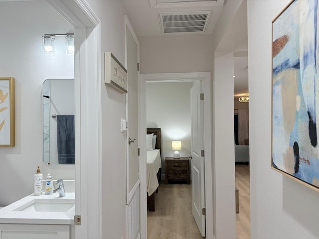 17099 Carleen Ave, Port Charlotte, FL 33948 - hallway with a sink and light wood finished floors