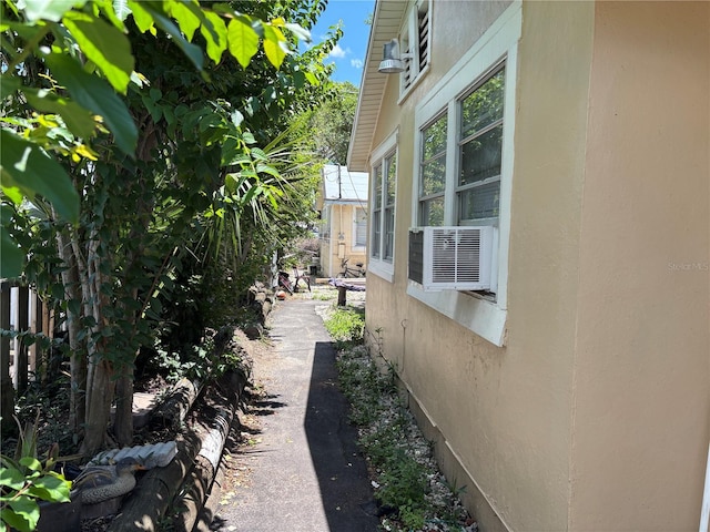 4213 W Cayuga St, Tampa, FL 33614 - view of side of home featuring stucco siding and cooling unit