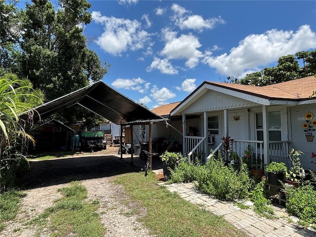 4213 W Cayuga St, Tampa, FL 33614 - view of front of house featuring driveway, a carport, a porch, and roof with shingles
