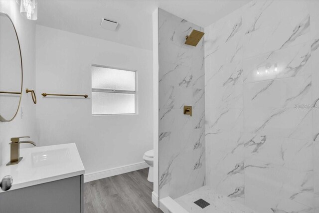 2711 E 22nd Ave, Tampa, FL 33605 - full bathroom featuring vanity, toilet, a marble finish shower, and baseboards
