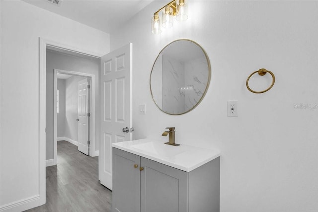 2711 E 22nd Ave, Tampa, FL 33605 - bathroom with vanity, wood finished floors, and baseboards