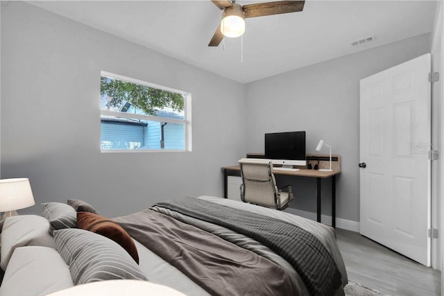 2711 E 22nd Ave, Tampa, FL 33605 - bedroom with light wood finished floors, ceiling fan, and baseboards
