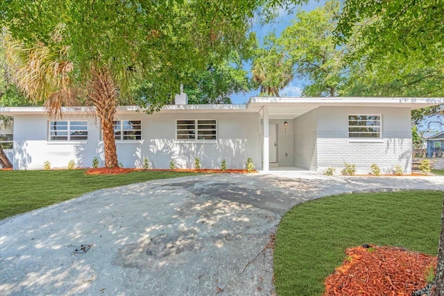 2711 E 22nd Ave, Tampa, FL 33605 - single story home with driveway, a front lawn, brick siding, and stucco siding