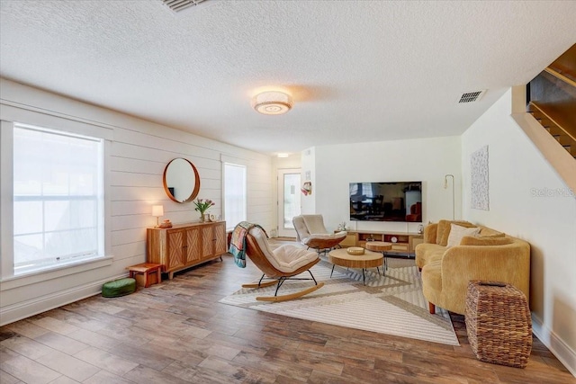 11121 Running Pine Dr, Riverview, FL 33569 - living area with plenty of natural light, a textured ceiling, wood finished floors, stairs, and baseboards