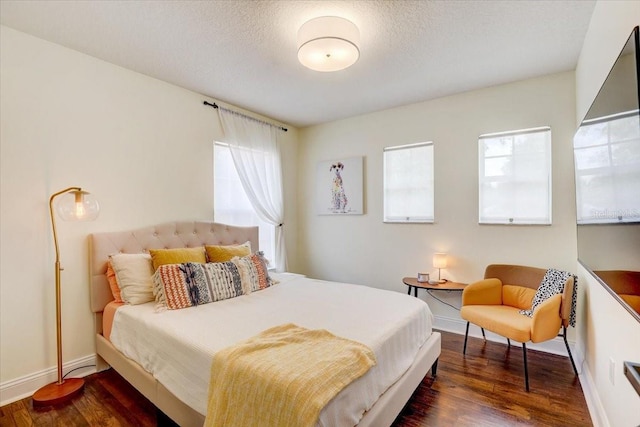 11121 Running Pine Dr, Riverview, FL 33569 - bedroom featuring wood finished floors, baseboards, and a textured ceiling