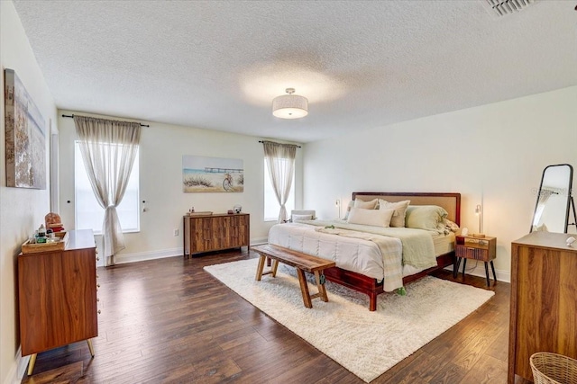 11121 Running Pine Dr, Riverview, FL 33569 - bedroom featuring dark wood-style flooring, a textured ceiling, and baseboards