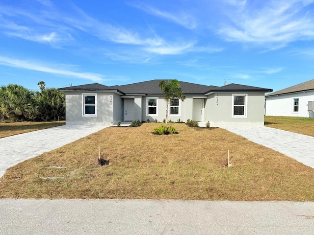 12223 Kirk Ave, Port Charlotte, FL 33981 - view of front facade featuring stucco siding and a front yard