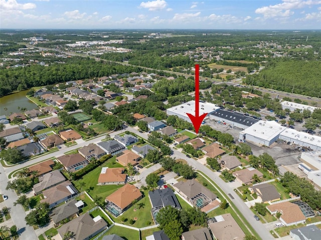 aerial view of property's location featuring a nearby body of water and nearby suburban area