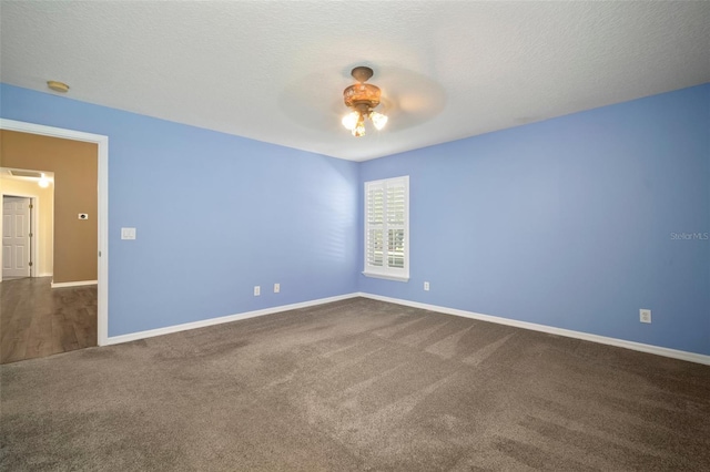 empty room with ceiling fan, carpet floors, and baseboards