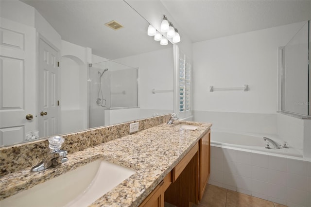 bathroom featuring a stall shower, a garden tub, tile patterned flooring, and double vanity