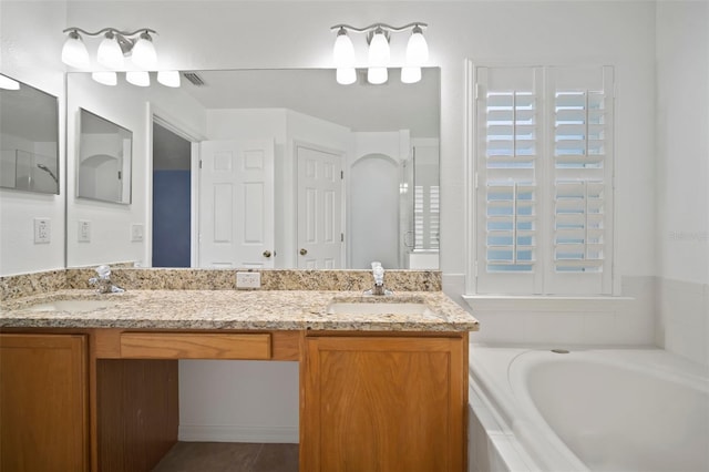 full bath with double vanity and a bath