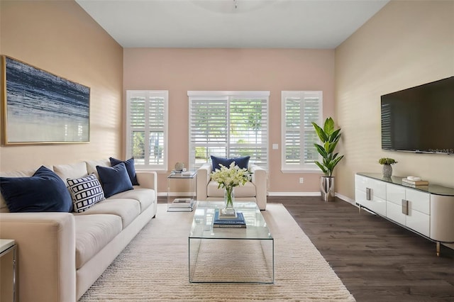 living area with dark wood finished floors and baseboards