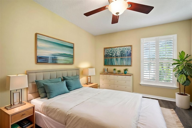 bedroom with baseboards, wood finished floors, and a ceiling fan