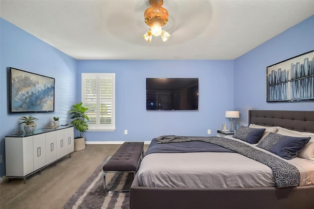 carpeted bedroom featuring baseboards and a ceiling fan