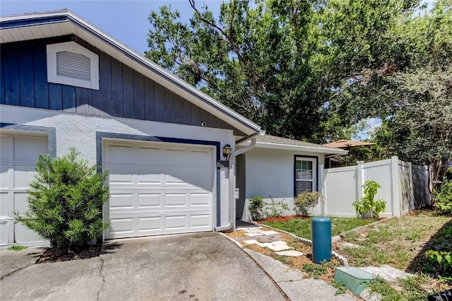 2721 Baird Ct, Palm Harbor, FL 34684 - ranch-style house with driveway, fence, stucco siding, and an attached garage