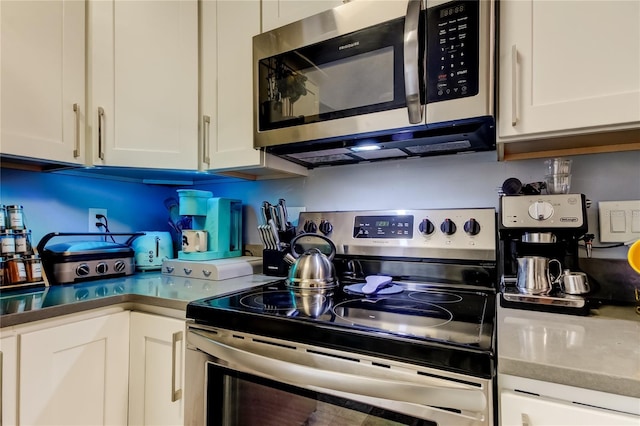 2721 Baird Ct, Palm Harbor, FL 34684 - kitchen with stainless steel appliances and white cabinets