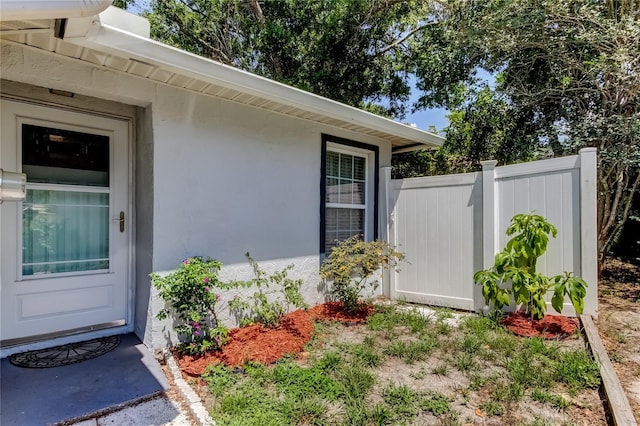2721 Baird Ct, Palm Harbor, FL 34684 - property entrance featuring fence and stucco siding