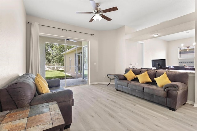 3023 Minuteman Ln, Brandon, FL 33511 - living room with light wood finished floors, baseboards, and ceiling fan