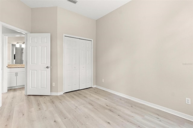 3023 Minuteman Ln, Brandon, FL 33511 - unfurnished bedroom with light wood-style flooring, baseboards, and a closet