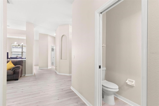 3023 Minuteman Ln, Brandon, FL 33511 - hallway with wood finished floors, baseboards, and a chandelier