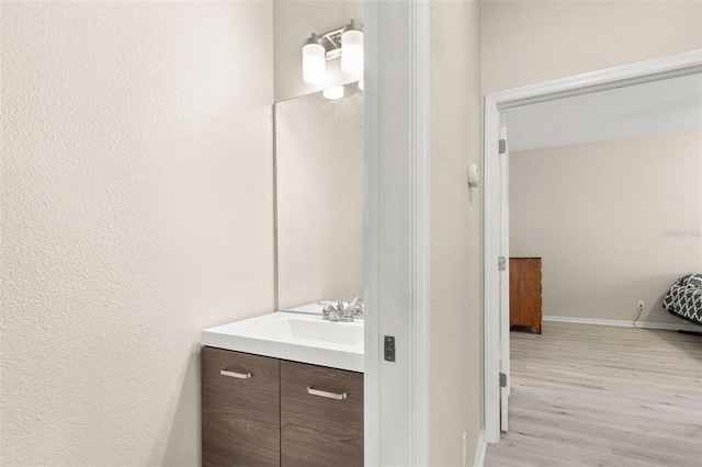 3023 Minuteman Ln, Brandon, FL 33511 - bathroom featuring vanity, wood finished floors, and baseboards