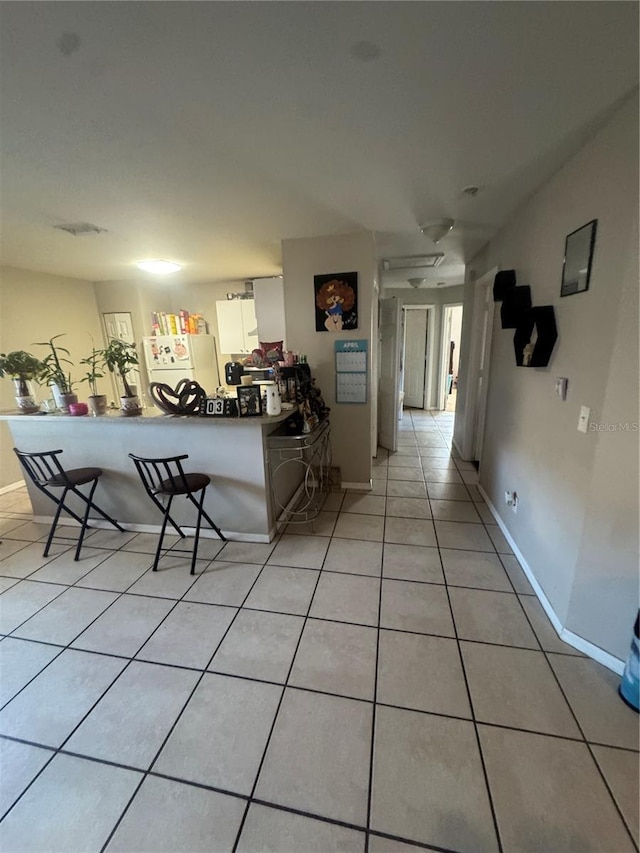 3710 N 57th St, Tampa, FL 33619 - living area featuring light tile patterned floors and baseboards