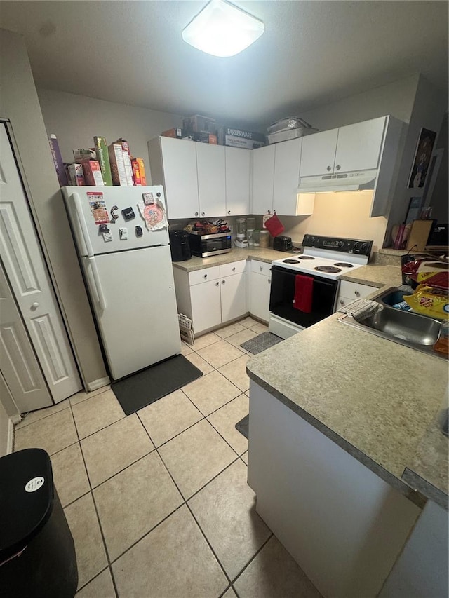3710 N 57th St, Tampa, FL 33619 - kitchen with white appliances, under cabinet range hood, light tile patterned flooring, and white cabinets