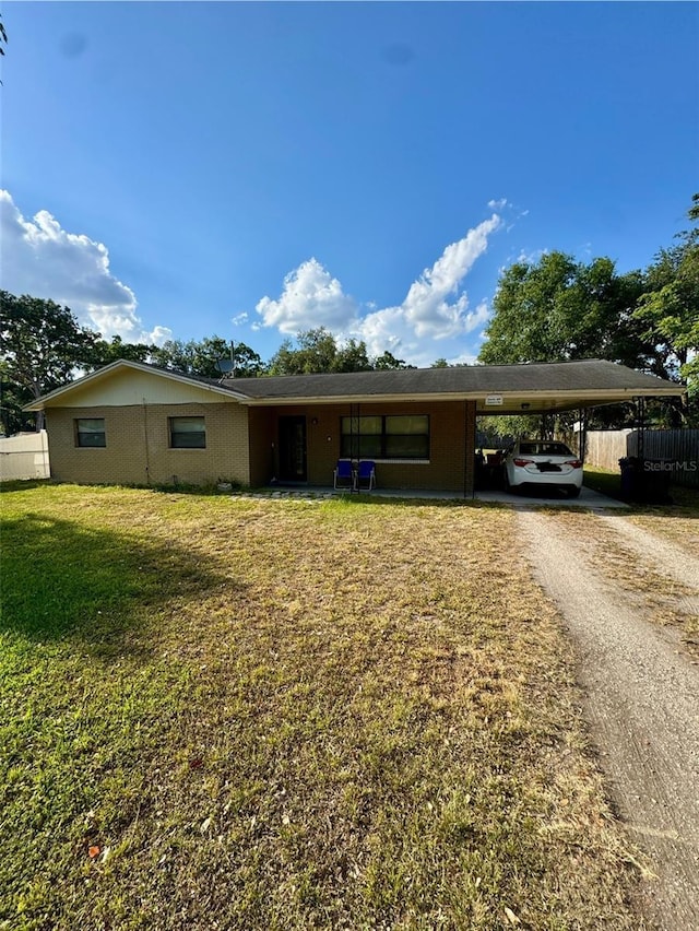 7620 32nd Ave S, Tampa, FL 33619 - view of front facade featuring an attached carport and dirt driveway