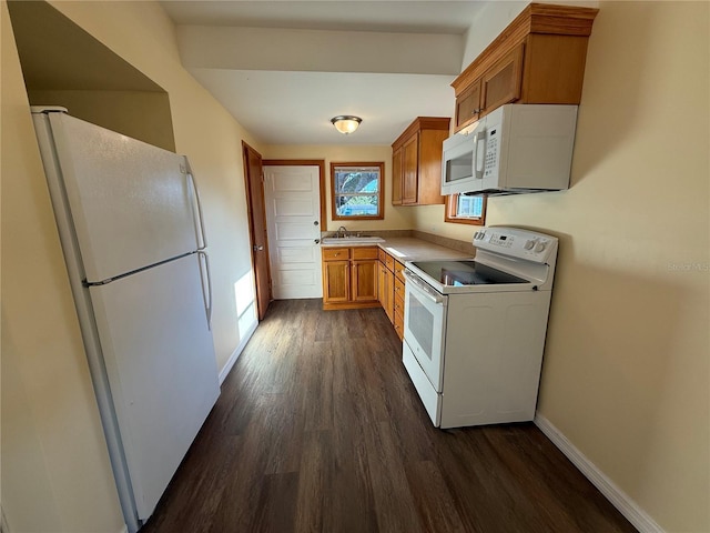 3762 18th Ter S, Saint Petersburg, FL 33711 - kitchen with white appliances, a sink, dark wood finished floors, brown cabinets, and baseboards
