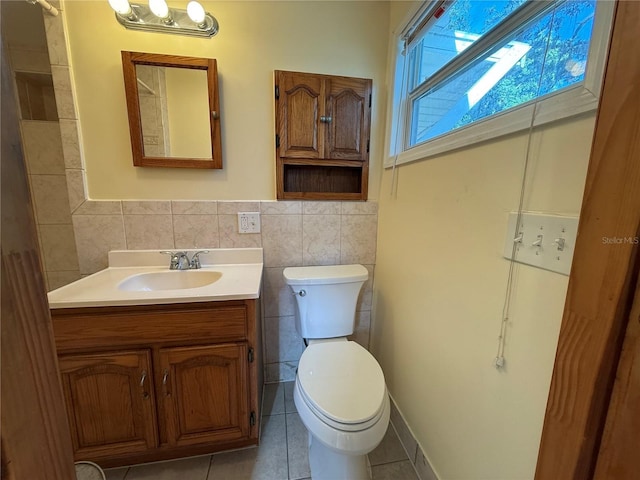3762 18th Ter S, Saint Petersburg, FL 33711 - bathroom with tile walls, vanity, tile patterned floors, toilet, and a wainscoted wall