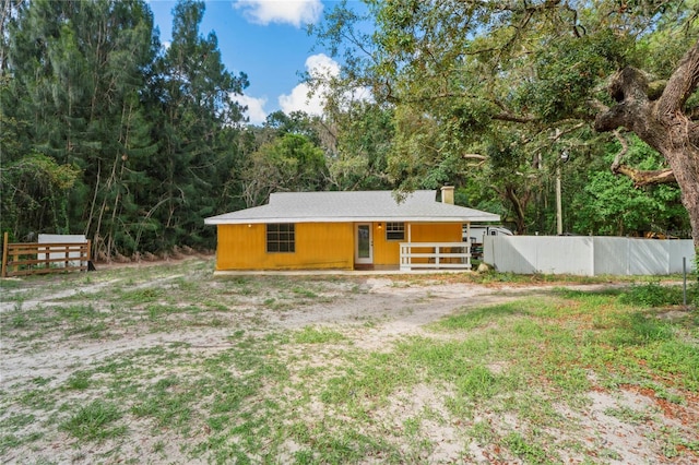 8828 Jasmine Blvd, Port Richey, FL 34668 - rear view of property with a chimney